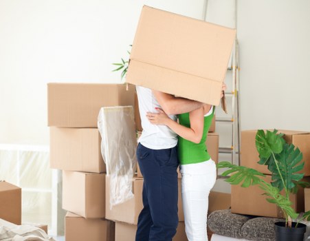 Movers handling furniture in a flat with stairs in Clapham